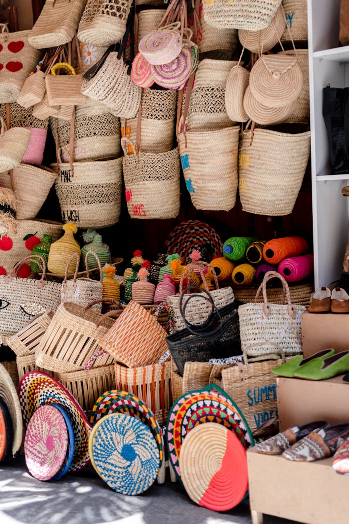 Vibrant display of handmade wicker bags and baskets at a Marrakech market, showcasing Moroccan craftsmanship.